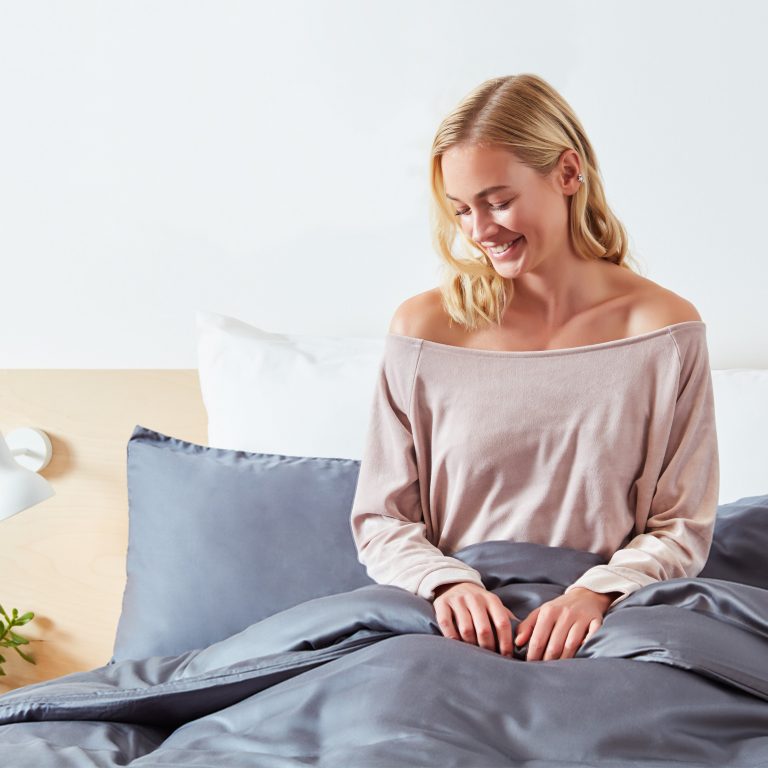 Woman Smiling In Bed With Panda London 100 Bamboo Bedding Urban Grey